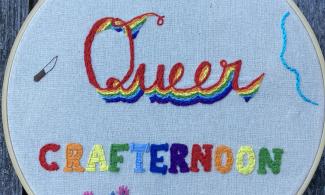 Embroidery of Queer Crafternoon with flowers around text